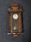 An antique Vienna wall clock with brass and enameled dial.