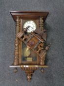 An antique Vienna wall clock with brass and enameled dial.