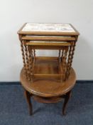A nest of three tile topped barley twist leg tables together with a circular occasional table.