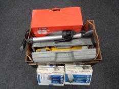 A box containing car accessory kits, cased trolley jack, 13 inch wheel trims, etc.