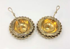 A heavy pair of Georgian gilt metal salts with spoons