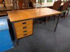 A mid 20th century teak single pedestal desk on metal legs.