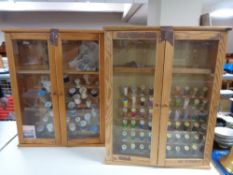 Two pine double door glazed wall cabinets containing sewing threads.