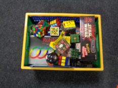 A box containing a quantity of Rubiks cubes and puzzles.