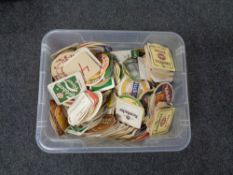 A box containing a large quantity of assorted beer mats.