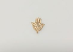 A gold diamond set hand pendant CONDITION REPORT: 2.