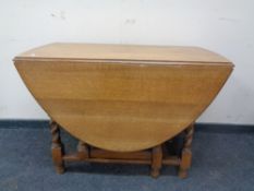 An Edwardian oak barley twist gate leg table.