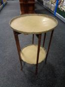 A Chinese style folding table with two brass lift off trays.