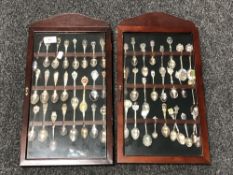 Two spoon display cases containing a quantity of continental silver and plated teaspoons.
