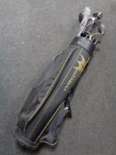 A golf bag containing assorted drivers,