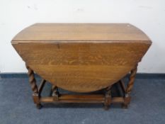 An Edwardian oak barley twist gate leg table.