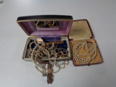 Two boxes containing assorted costume jewellery to include coin bracelets, pearl necklaces,
