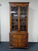 A Regency style mahogany double door bookcase with glazed doors,