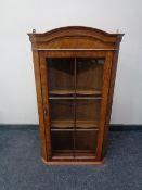 A yew wood hanging corner display cabinet.