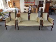 A late 19th century inlaid mahogany three piece lounge suite upholstered in a green dralon.