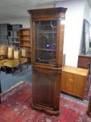 A reproduction Georgian style corner display cabinet, fitted cupboard beneath.