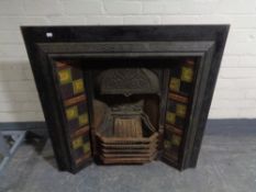 A Victorian cast iron tiled fire insert