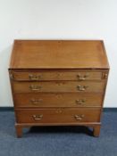 A George III mahogany writing bureau, fitted four drawers with brass drop handles.
