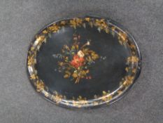 A Victorian papier mache tray with hand painted floral and grape leaf decoration (losses)