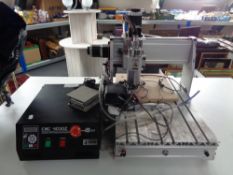 A CNC 4030Z desktop CNC engraving machine with control unit and accessories.