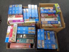 Three boxes containing a large quantity of assorted jigsaws.