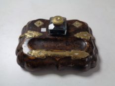 A late nineteenth century walnut desk stand with brass mounts and glass inkwells