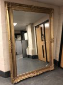 An impressive gilt framed leaning 7' x 5' mirror.