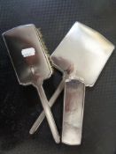 A three piece Birmingham silver dressing table brush and hand mirror set