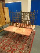A set of four wrought iron high backed dining chairs