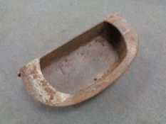 An antique cast iron wall trough.