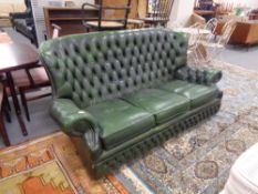 A Chesterfield high backed green buttoned leather settee