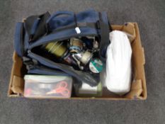 A box containing a large quantity of fishing equipment to include reels, line tackle etc.