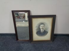 An Edwardian oak framed bevelled mirror together with an oak framed portrait of a man