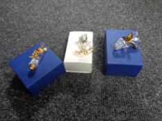 Three boxed Swarovski crystal ornaments to include golf clubs and bag,