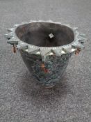 A pottery vase with sunburst rim signed to base