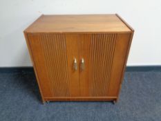 A mid 20th century teak double door record cabinet.