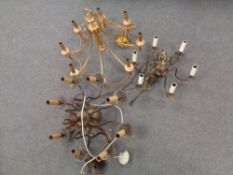 A decorative brass eight way light fitting together with two further copper light fittings.