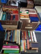 Four boxes containing assorted books to include Penguin paperback novels, Tolkien, reference etc.