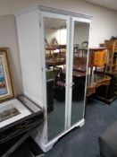A painted Ducal pine double door mirrored wardrobe