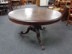 A Victorian mahogany circular tilt-top breakfast table on carved three way pedestal