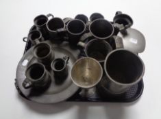 A tray of seventeen pieces of antique and later pewter to include graduated tankards,