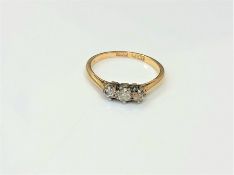 An 18ct gold and platinum three stone diamond ring,