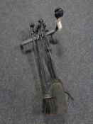 A four piece cast iron companion set with fire dog, with ram's head handles.