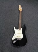 An Encore left-handed electric guitar.