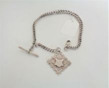 A silver graduated pocket watch chain with ornate silver fob and T-bar, dated Birmingham 1901,