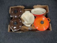 A box of Le Creuset cast iron and ceramic oven dishes and lidded pans