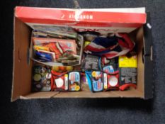 A box containing tea cards and albums, pin badges, Paul Daniels magic tricks, union jack flag,