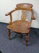 An antique elm and beech smoker's armchair