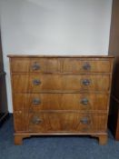 A George III style mahogany five drawer chest on bracket feet