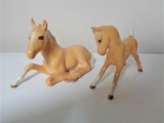 Two Beswick foals.
